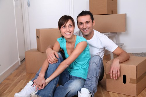 Professional movers handling a delicate item in a Holland Park home
