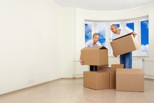 Removal team unloading boxes into a family home