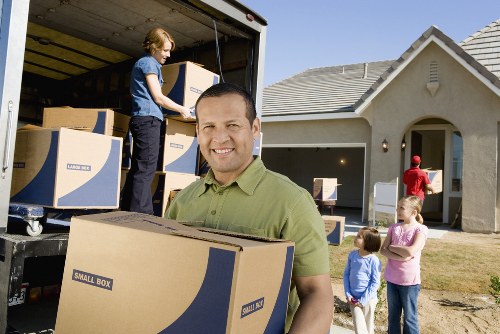 Furniture and boxes being loaded into a moving van in West London